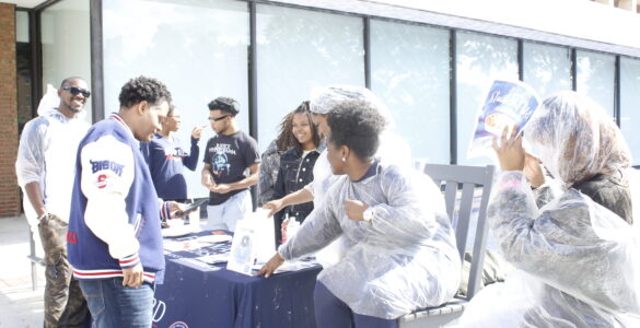 Members of the SVA host a fundraiser in front of the Blackburn Center while trying to convince Dr. Paris Adon, left, to join.