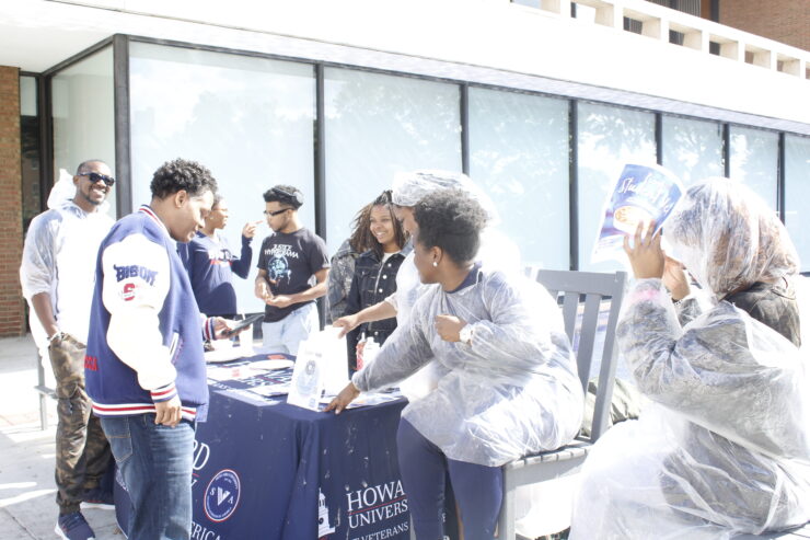 Members of the SVA host a fundraiser in front of the Blackburn Center while trying to convince Dr. Paris Adon, left, to join.