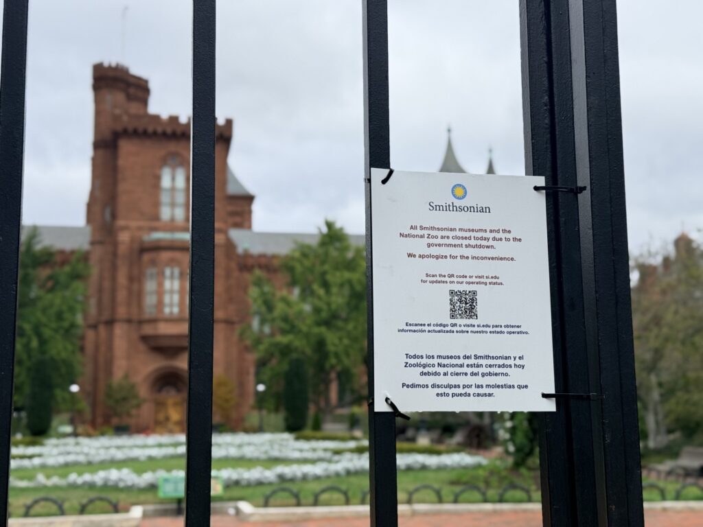 A closure sign hangs on the gate outside a Smithsonian Institution building. (Kordell Martin)