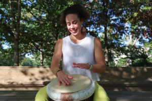 Cassi Wright playing the djembe at Malcolm X Park. (Kelly Doyle)
