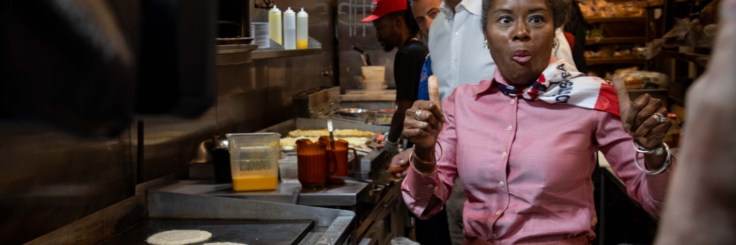 Winsome Earle-Sears, the Republican lieutenant governor of Virginia who is running for the top job, flips pancakes at Shorty's Diner in Richmond with a little help from her boss,Gov. Glenn Youngkin, on Monday. Voters will elect their first female governor on Tuesday. Photo by Ben Ackman