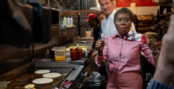 Winsome Earle-Sears, the Republican lieutenant governor of Virginia who is running for the top job, flips pancakes at Shorty's Diner in Richmond with a little help from her boss,Gov. Glenn Youngkin, on Monday. Voters will elect their first female governor on Tuesday. Photo by Ben Ackman