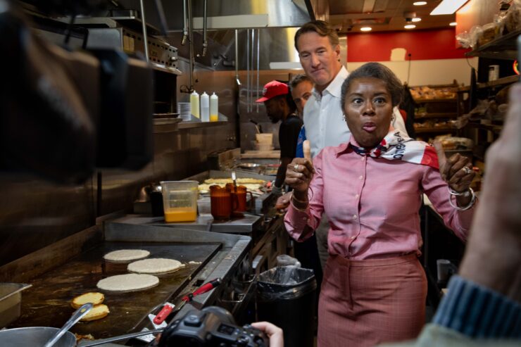 Winsome Earle-Sears, the Republican lieutenant governor of Virginia who is running for the top job, flips pancakes at Shorty's Diner in Richmond with a little help from her boss,Gov. Glenn Youngkin, on Monday. Voters will elect their first female governor on Tuesday. Photo by Ben Ackman