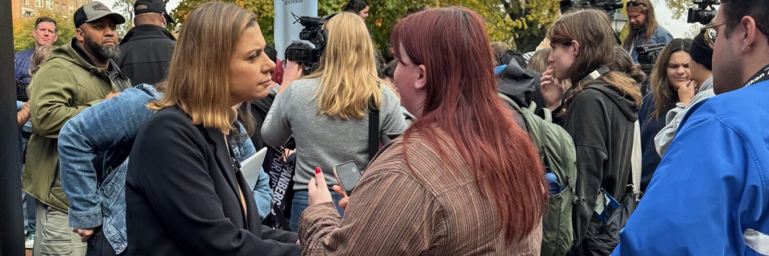 Eagle Editor-in-Chief Walker Whalen interviews a voter and a Spanberger rally on Monday. Photo by Robert Barnes