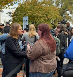 Eagle Editor-in-Chief Walker Whalen interviews a voter and a Spanberger rally on Monday. Photo by Robert Barnes