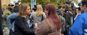 Eagle Editor-in-Chief Walker Whalen interviews a voter and a Spanberger rally on Monday. Photo by Robert Barnes