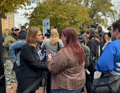 Eagle Editor-in-Chief Walker Whalen interviews a voter and a Spanberger rally on Monday. Photo by Robert Barnes