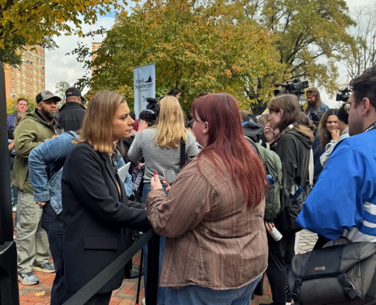 Eagle Editor-in-Chief Walker Whalen interviews a voter and a Spanberger rally on Monday. Photo by Robert Barnes