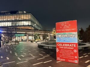 A sign for the Holiday Boat Parade and Party displayed on The Wharf. (Kordell Martin)