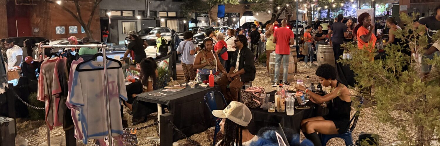 A group of people gather in the Anacostia business corridor for the Art All Night Anacostia festival.