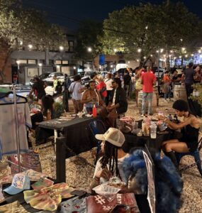 A group of people gather in the Anacostia business corridor for the Art All Night Anacostia festival.