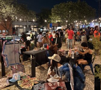 A group of people gather in the Anacostia business corridor for the Art All Night Anacostia festival.