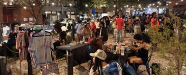 A group of people gather in the Anacostia business corridor for the Art All Night Anacostia festival.