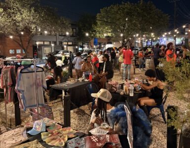 A group of people gather in the Anacostia business corridor for the Art All Night Anacostia festival.