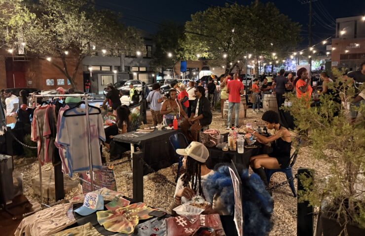 A group of people gather in the Anacostia business corridor for the Art All Night Anacostia festival.