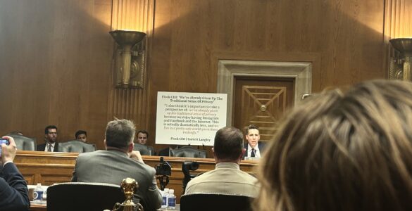 Sen. Josh Hawley sits in front of a white poster board with a statement from Flock CEO Garrett Langley in Dirksen Senate Office Building.
