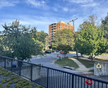 A picture of Edinburgh House, a brown low rise brick building, from across the street on Maple Avenue in Takoma Park.