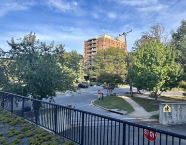 A picture of Edinburgh House, a brown low rise brick building, from across the street on Maple Avenue in Takoma Park.