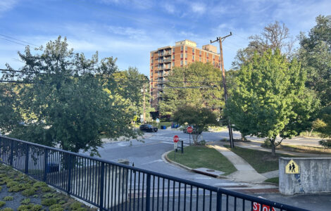 A picture of Edinburgh House, a brown low rise brick building, from across the street on Maple Avenue in Takoma Park.
