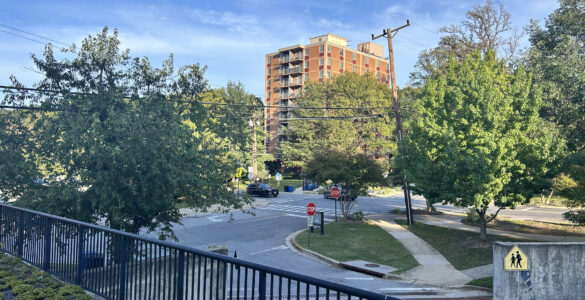 A picture of Edinburgh House, a brown low rise brick building, from across the street on Maple Avenue in Takoma Park.