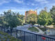 A picture of Edinburgh House, a brown low rise brick building, from across the street on Maple Avenue in Takoma Park.