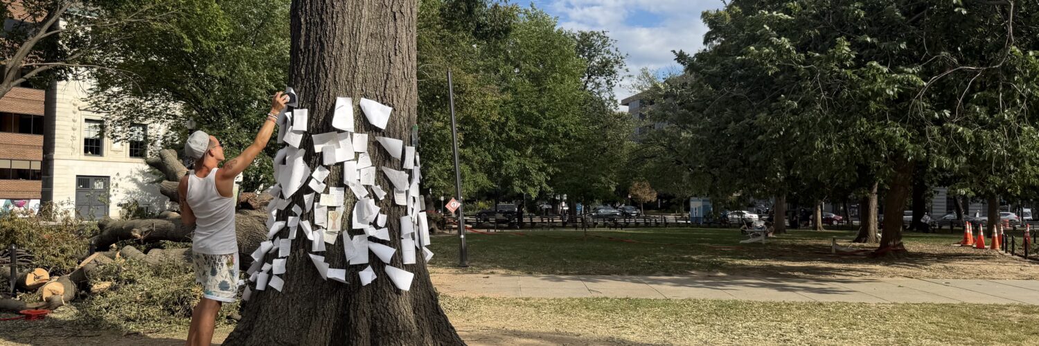 Northern Virginia resident pins message to stump in Dupont Circle Park.