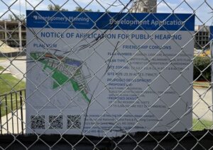 Notice of Application for Public Hearing sign at old GEICO demolition site