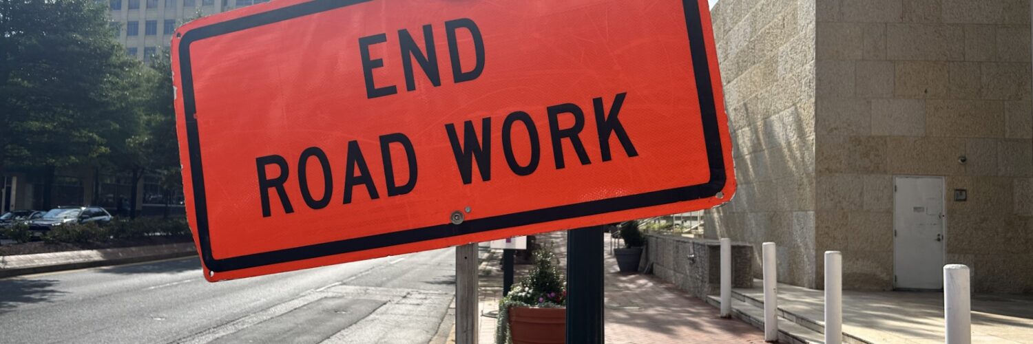 An orange warning sign that says "End Road Work" at the end of construction on Georgia Avenue in Silver Spring.