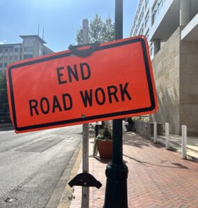 An orange warning sign that says "End Road Work" at the end of construction on Georgia Avenue in Silver Spring.