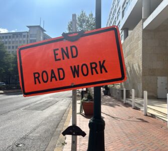 An orange warning sign that says "End Road Work" at the end of construction on Georgia Avenue in Silver Spring.