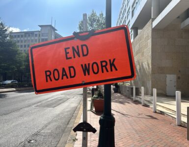 An orange warning sign that says "End Road Work" at the end of construction on Georgia Avenue in Silver Spring.