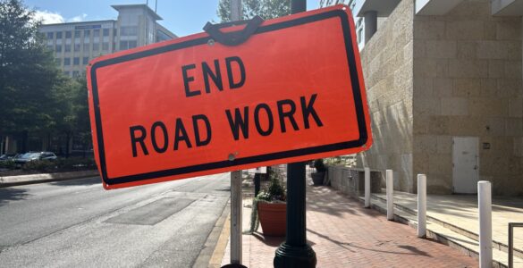 An orange warning sign that says "End Road Work" at the end of construction on Georgia Avenue in Silver Spring.