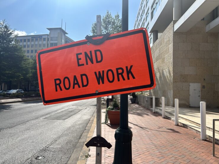 An orange warning sign that says "End Road Work" at the end of construction on Georgia Avenue in Silver Spring.