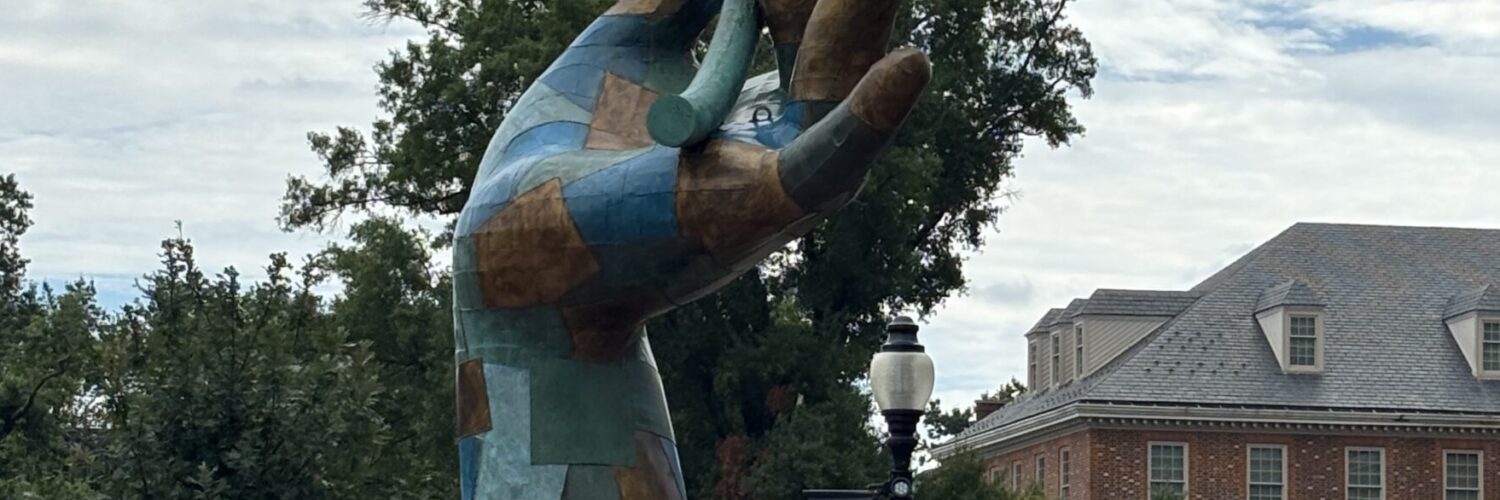 A public sculpture of a giant hand holding a leaf stands in the park at City Ridge in Cathedral Heights. (Photo by Albina Yeromina)
