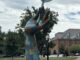 A public sculpture of a giant hand holding a leaf stands in the park at City Ridge in Cathedral Heights. (Photo by Albina Yeromina)