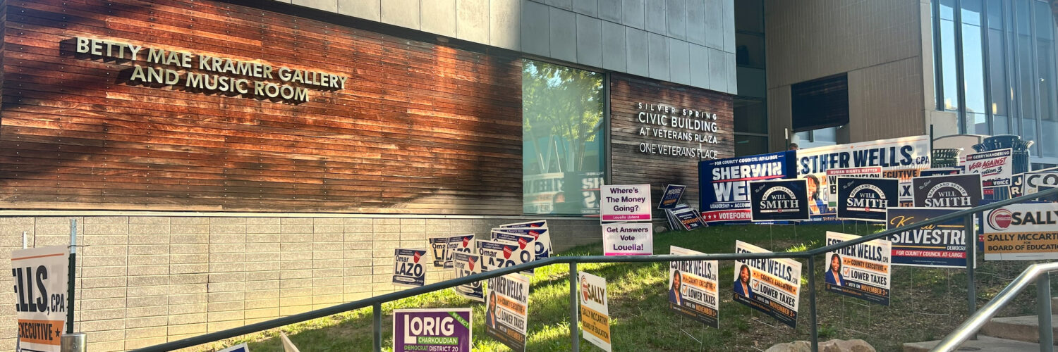 Campaign signs lined up on the grass outside of the Silver Spring Civic Building.