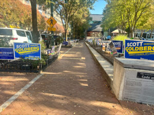Colorful campaign signs on the side of a brick sidewalk near the Silver Spring Civic building.