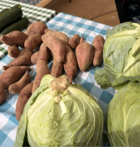 Three side-by-side images show an array of vegetables at the FRESHFARM ACM market. Photo by Ashayla Byrd