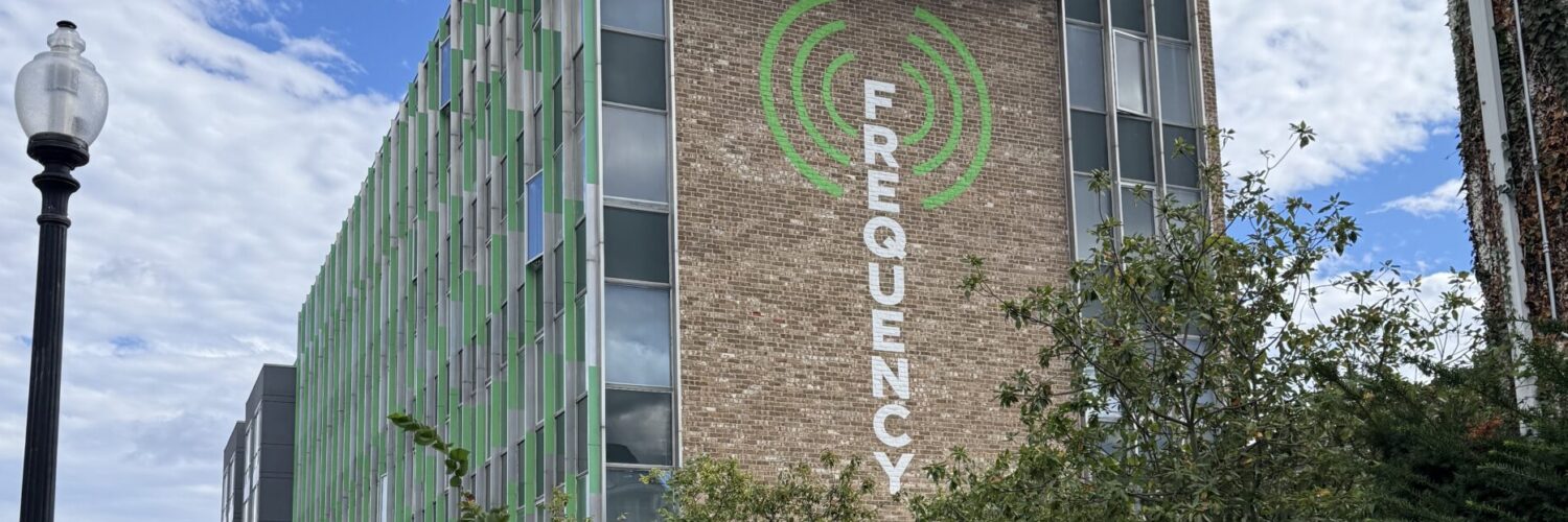The Frequency building with logo painted on side