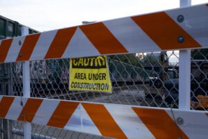 Photo of construction sign on railway with track construction behind it.